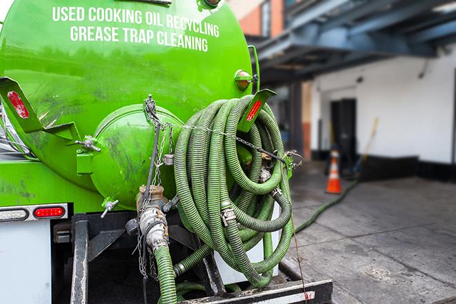 a vacuum truck pumping out a large underground grease trap in Bridgeview